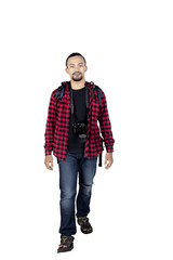 Fototapeta premium Male backpacker walking in studio