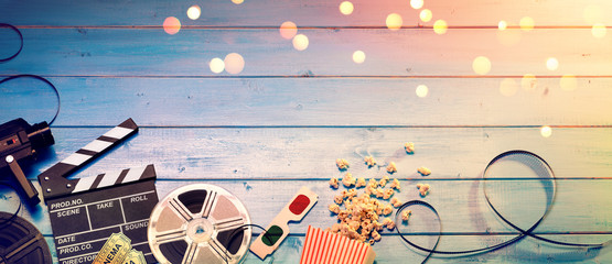 Cinema Film Background - Vintage Effect - Camera With Clapperboard, Tickets, Rolls, Glasses And Popcorn
 - obrazy, fototapety, plakaty