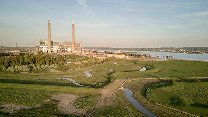 Tilbury Power Stations, Essex. The decommissioned coal power stations with pylons behind feeding energy into the UK National Grid electricity network.