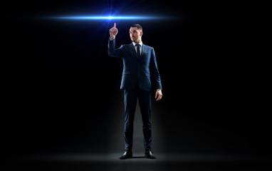 Fototapeta na wymiar businessman in suit pointing finger to laser light