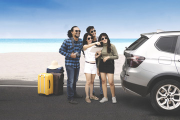 Young people standing near the beach