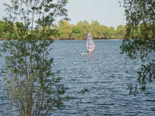 one man is windsurfing on a lake