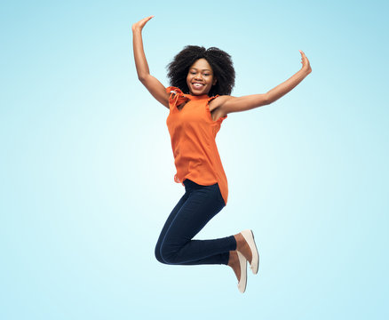 Happy African American Woman Jumping Over White