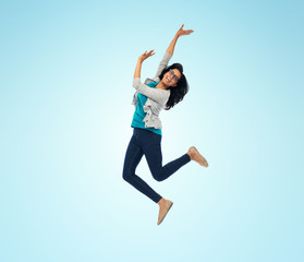 Fototapeta na wymiar smiling young indian woman jumping in air