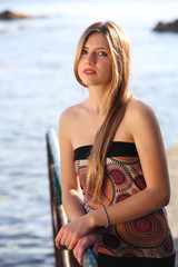 Young attractive woman near the sea on a spring day