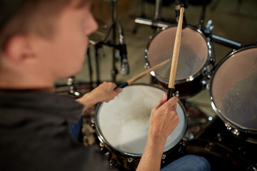man playing drums at concert or music studio