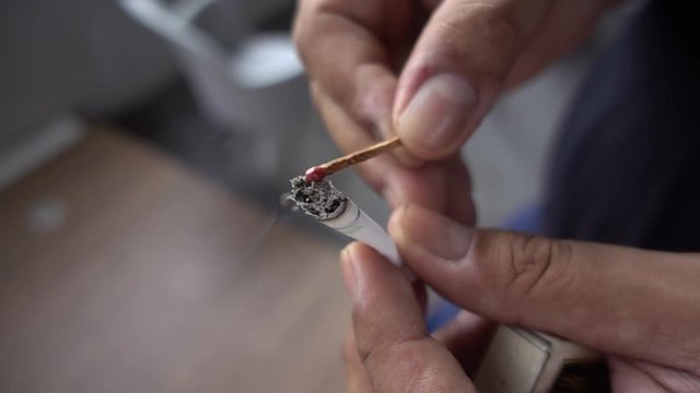 Men are bringing matches to spot with cigarettes sparks