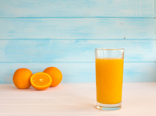 Glass of orange juice from above on vintage wood table. Empty ready for your orange juice, fruit product display or montage.