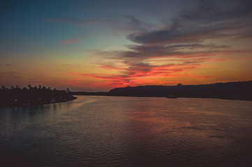 View from the bridge over the river to a incredible sunset with illuminated clouds