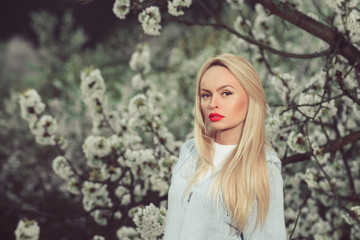 garden with spring flowers and woman