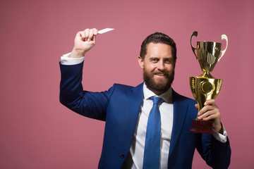 happy businessman, man with golden champion cup and credit card