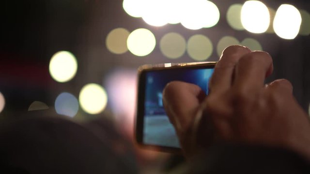 4K Asian spectator using smartphone for take a video with camera phone of the dancing Dragon in Chinese New Year Celebration at Miaoli. Festival of Hakka Dragon Bombing Dance in Taiwan-Dan