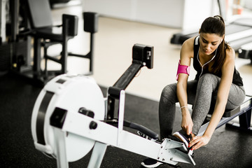Young woman preparing for workout at the gym