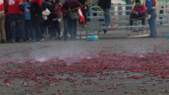 Slow motion Festival Taiwan of Hakka Dragon Bombing Dance. People dancing dragon up, down, side-to-side. Spectators throw fireworks and firecrackers. Explosions and smoke-Dan