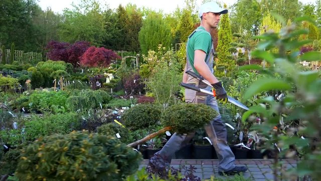 Garden Department Store Worker Walking with Scissors in Slow Motion
