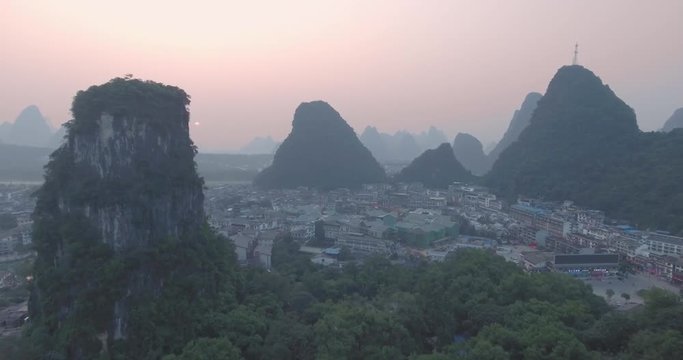 Top view of amaizing famous Yangshuo valley in Guilin, Guangxi, China. Aerial View of beautiful sunrise over Yangshuo Town in Guilin, China. Overpopulation concept, beauty in nature