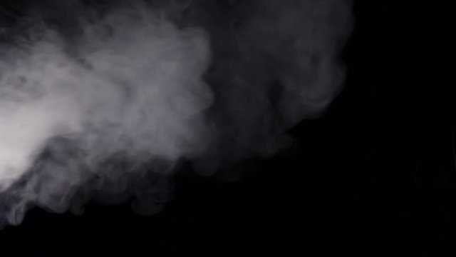 White smoke on the black background slow motion