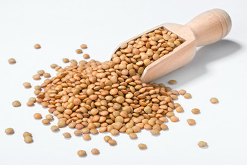 raw lentils in the wooden shovel, (large depth of field, taken with tilt shift lens)