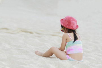 Little girl playing on beach