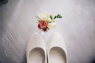 Elegant and stylish bridal shoes decorate flowers, beautiful bouquets for groom