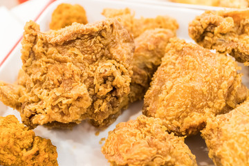 Fried chicken wings on wooden table. Breaded Crispy fried kentucky chicken tasty dinner.