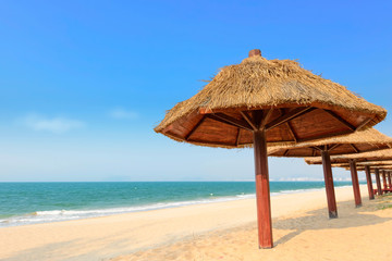 golden straw umbrella on the summer beach