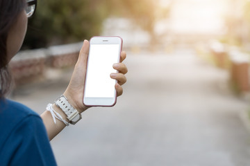 Woman hold cell phone with left hand. blurred background