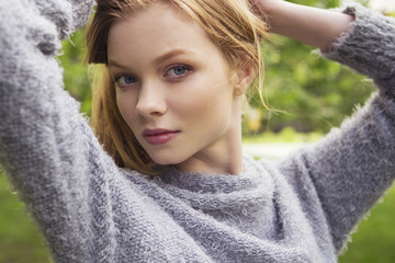 Beautiful red hair ginger slim young woman with fresh skin in casual outfit, posing. Sunny summer...