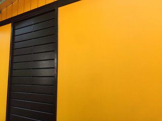 Dark Brown Wooden Door with Yellow Wall