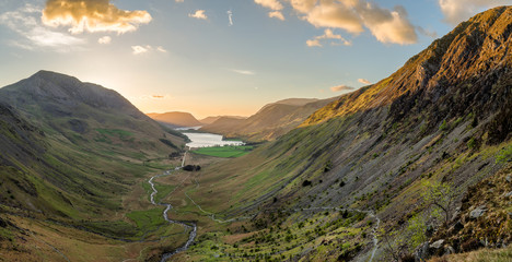 Golden sunlight hitting mountain tops at sunset overlooking Buttermere in the English Lake District.