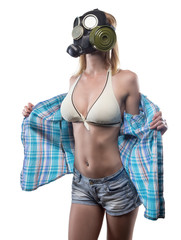 Young undressing woman in gas mask