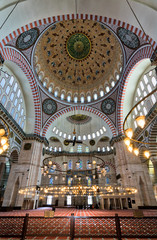 Interior low angle shot of Suleymaniye Mosque, an Ottoman imperial mosque built in 1557, located on the Third Hill of Istanbul, Turkey, and the second largest mosque in the city