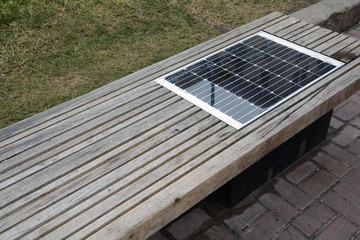 Bench with solar battery. Solar charging bench, solar powered connect devices at outdoor.