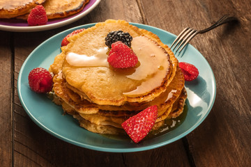 Homemade pancakes with fresh fruit and honey