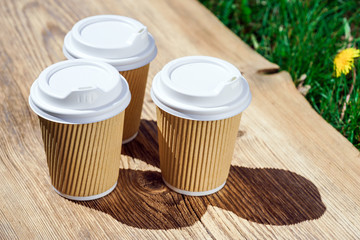 recycled paper coffee cup on wooden table