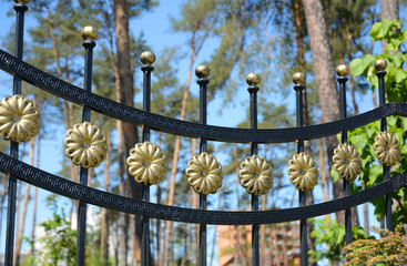 Beautiful wrought fence. Image of a decorative cast iron fence. metal fence close up. Metal Forged...
