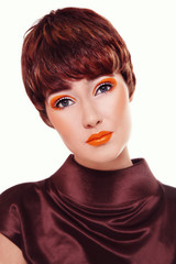 Vintage style portrait of young beautiful woman with fancy orange make-up