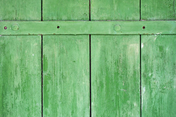 Peeling paint on an old rustic barn door, grunge background texture