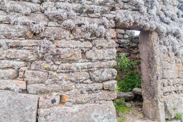 Door in a ruined house on Taquile island in Titicaca lake, Peru