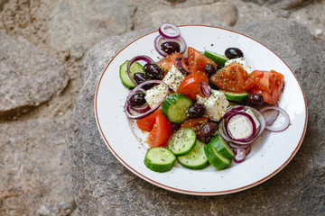 Greek salad with tomatoes, cucumbers, feta, red onions, olives