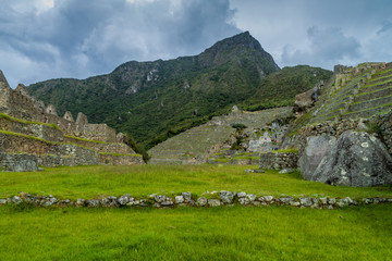 Fototapeta na wymiar Former agricultural terraces and buildings at Machu Picchu ruins, Peru