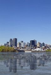 Fototapeta na wymiar View of Montreal city with reflection on the water, day