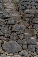 Fototapeta na wymiar Narrow steep stairs at Machu Picchu ruins, Peru
