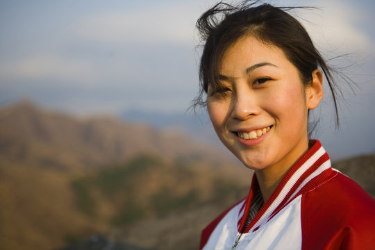 Portrait of young Chinese woman at the Great Wall Of China.