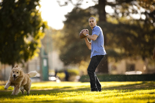 Mature man preparing to throw a football in the park
