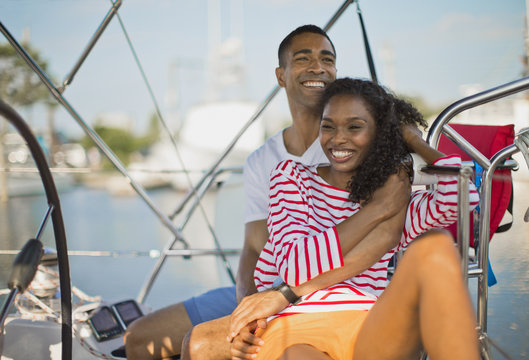Young couple relaxing and having fun while sailing.