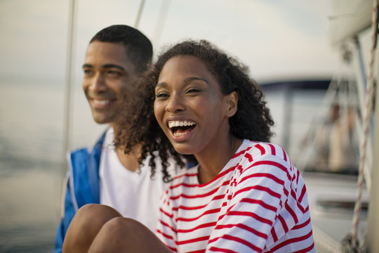 Young couple relaxing and having fun while sailing.