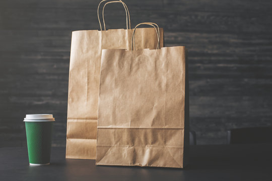 Brown shopping bags and coffee closeup