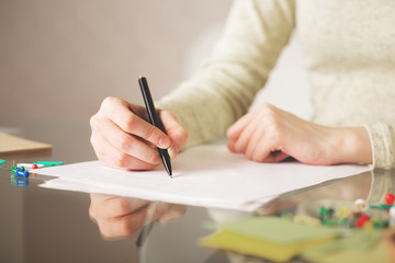 Female writing on paper