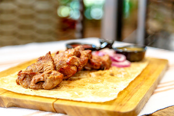 Ready skewers of pork lying on the cake on a wooden Board.